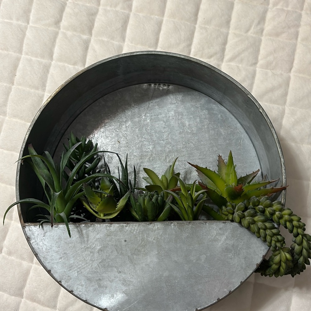 Galvanized metal hanging planter with faux succulents